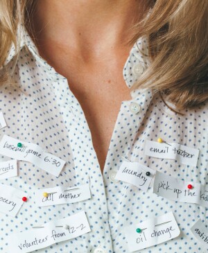 Busy Woman With Reminders Pinned To Her Shirt