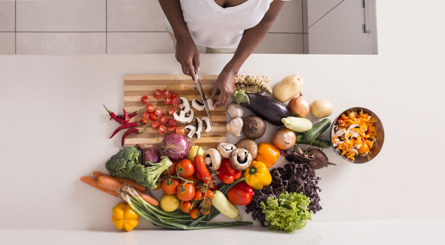 Unrecognized women preparing fresh healthy salad.