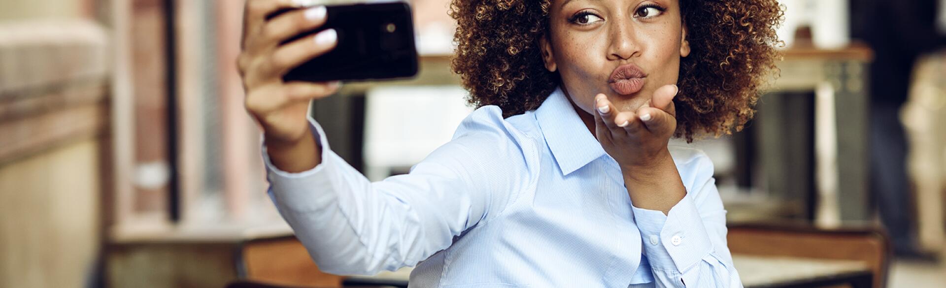 image_of_african_american_woman_taking_selfie_with_phone_GettyImages-946920772_1540