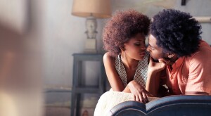 couple laying on bed getting intimate