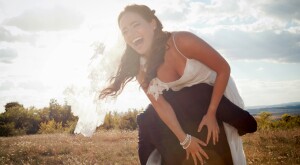 Groom carrying bride over his shoulder