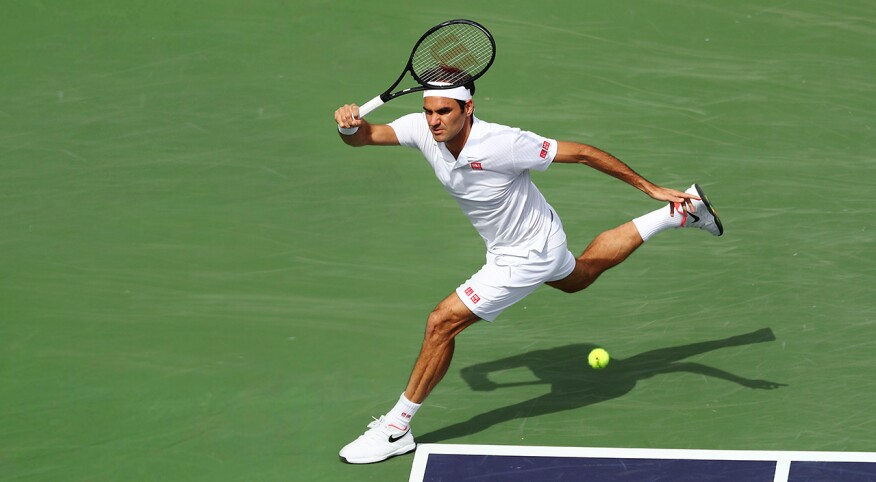 Tennis player Roger Federer hitting a ball during a match