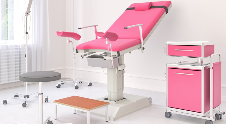 Gynecological room with pink chair and side table