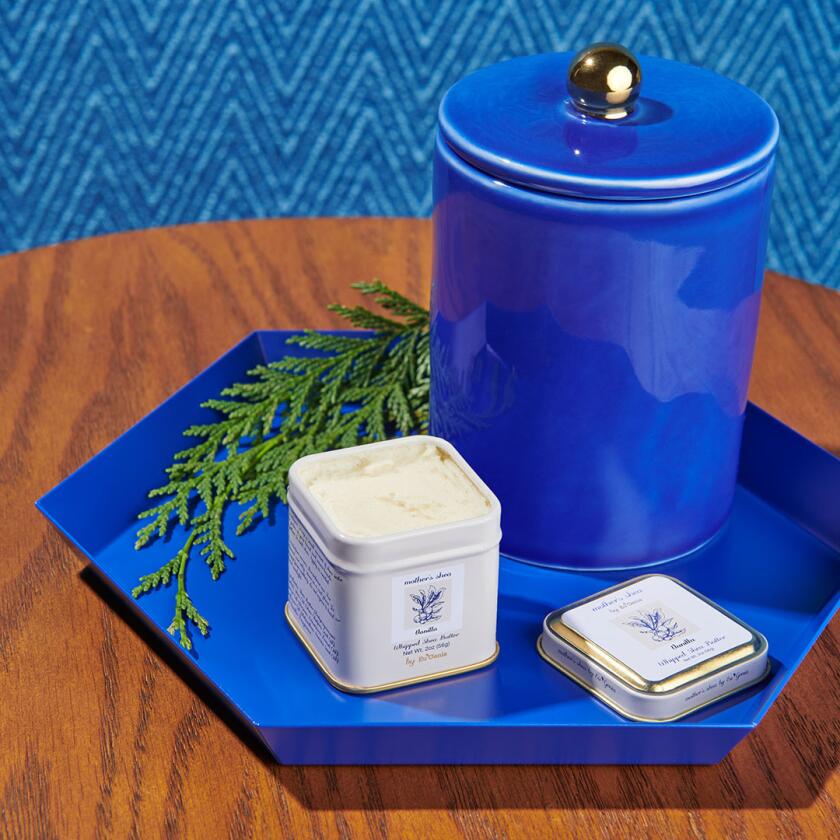 Jar of shea butter on a blue tray
