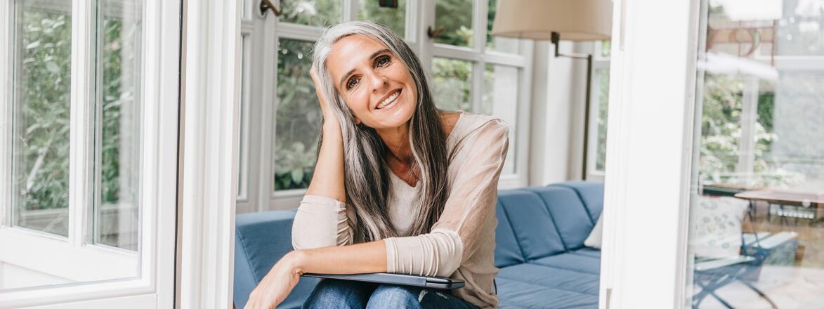 Woman with gray hair sitting on porch