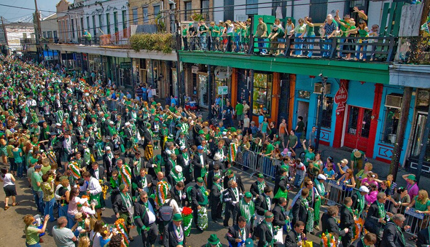 Men clad in beads parade down Magazine S