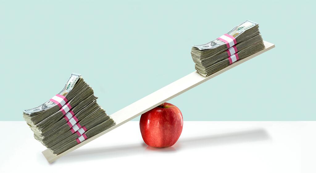 image of money on balance scale on top of apple