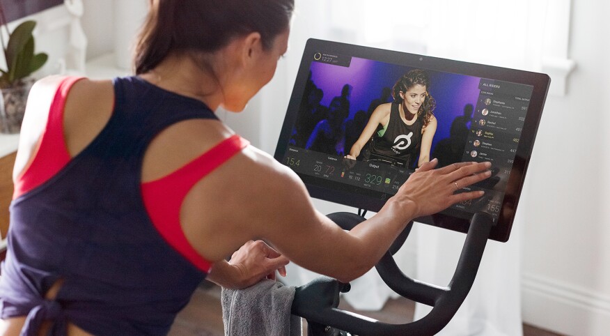 An image of a woman cycling during a Peloton class.