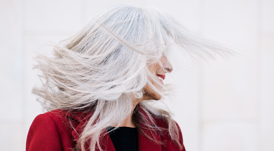 An image of a woman with long gray hair.