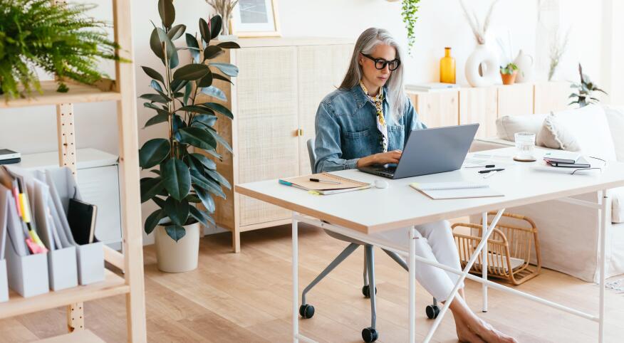 Middle Aged Woman Using Laptop In Home Office