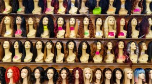 Mannequins with wigs on a shelf