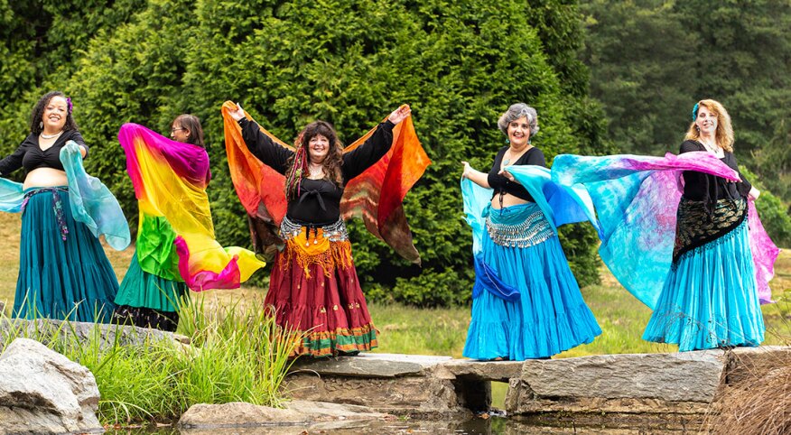 Group of women belly dancing outdoors