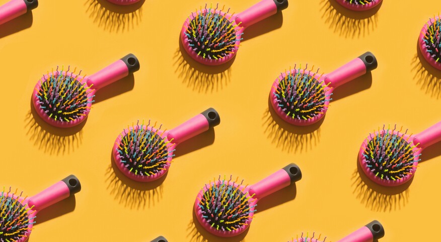 Repeating pink hair brushes casting shadows 