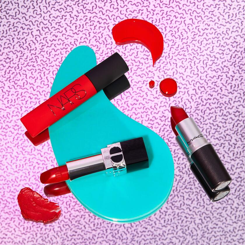 Red lip stick products on neon patterned background