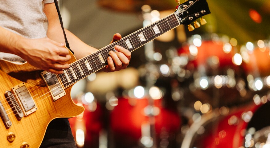 Musician playing guitar in live concert 