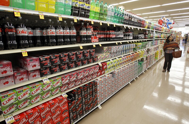 A shopper walks by the sodas aisle at a grocery store in Los Angeles