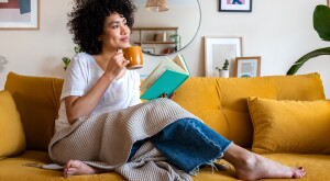 Woman sitting on the couch drinking a coffee