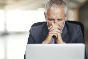 Man looking intently at laptop