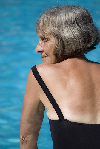 Profile of a beautiful older woman at a swimming pool