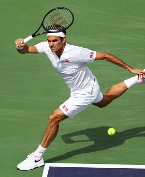 Tennis player Roger Federer hitting a ball during a match