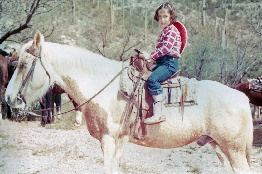Iris Krasnow on horseback a child at the Double U Ranch