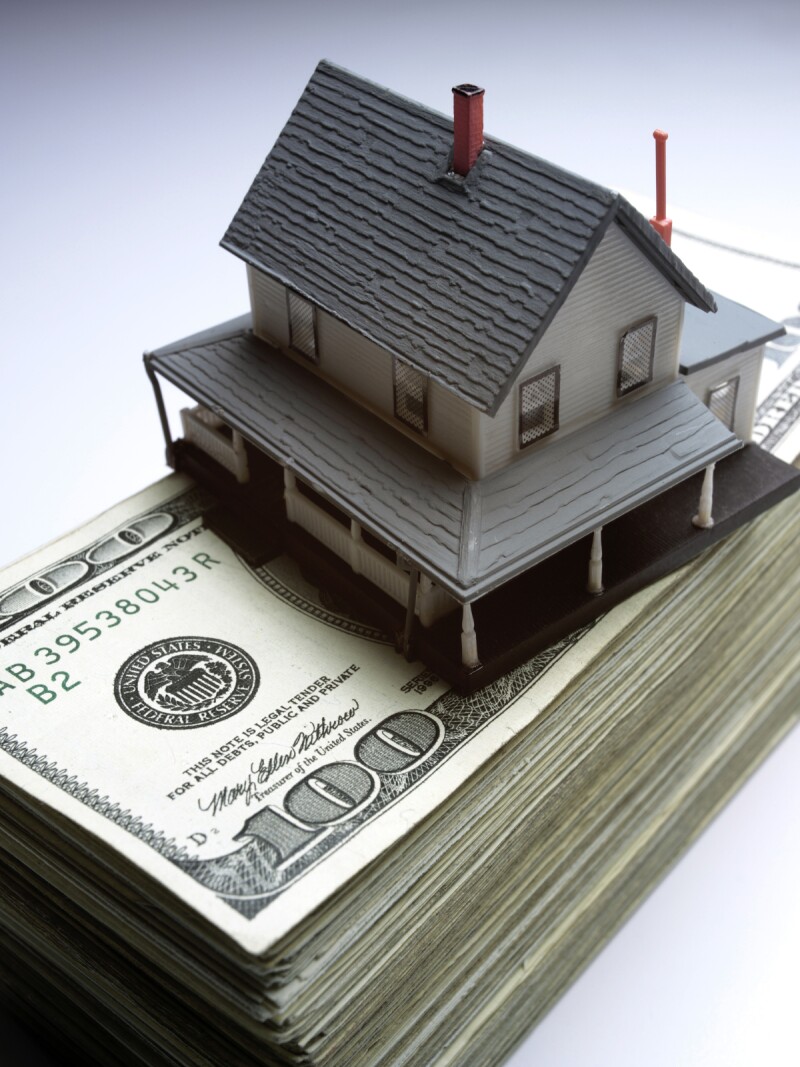 iStock_000001075147Medium house on money