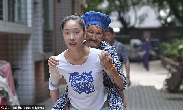 Chinese woman carrying her grandma