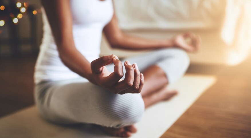 woman practicing guided meditation at home