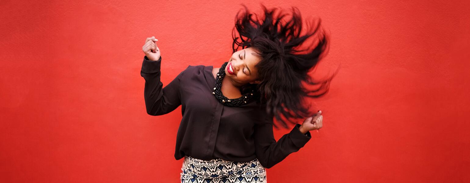 African American Woman Dancing on red background to cheer up