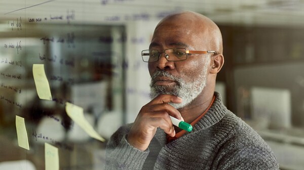Older Black male professional working on strategic issue