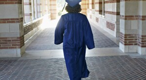 image_of_woman_in_graduate_robe_walking_from_behind_GettyImages-162749395_1800