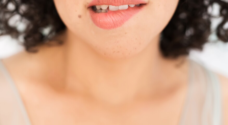 Up Close Of A Woman biting her lip 