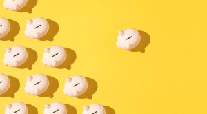 Piggy banks patterned on yellow background