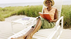 image_of_woman_reading_a_book_outside_on_beach_chair_GettyImages-200158560-001_1800