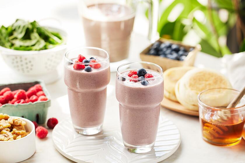 Summer smoothies styled on a white kitchen counter