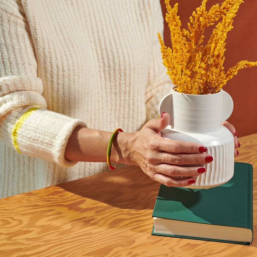 Red, gold and green cuff bracelet on woman's wrist