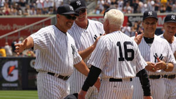 Whitey Ford, right, walks up to Reggie Jackson during The New York Yankees 65th Old Timers Day.