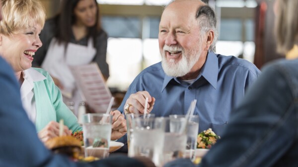 Older man in conversation at restaurant