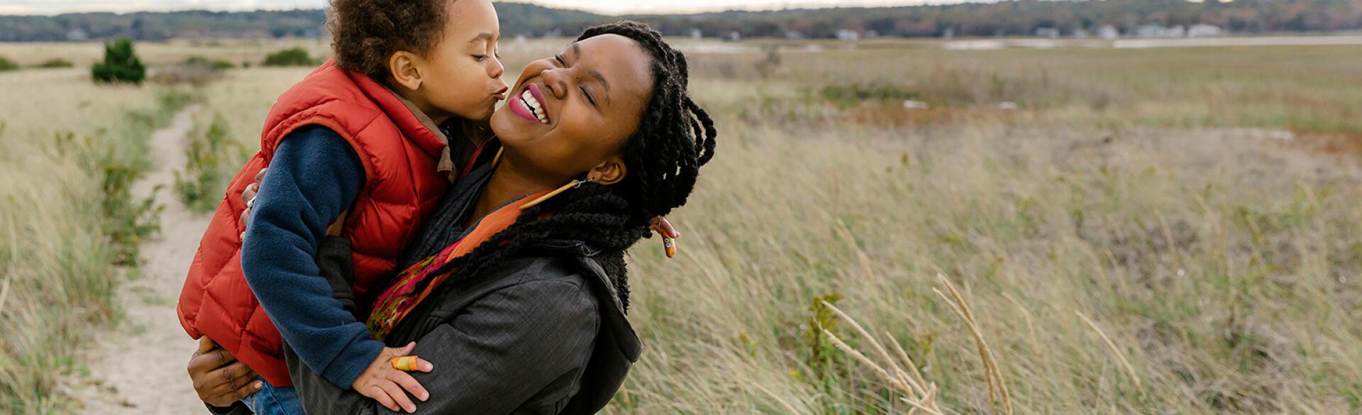 image_of_black_mother_holding_small_child_against_landscape_Stocksy_txpf9d9135aWFX200_OriginalDelivery_1284835_1540.jpg