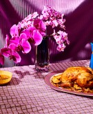 Roasted chicken on fuchsia colored table setting