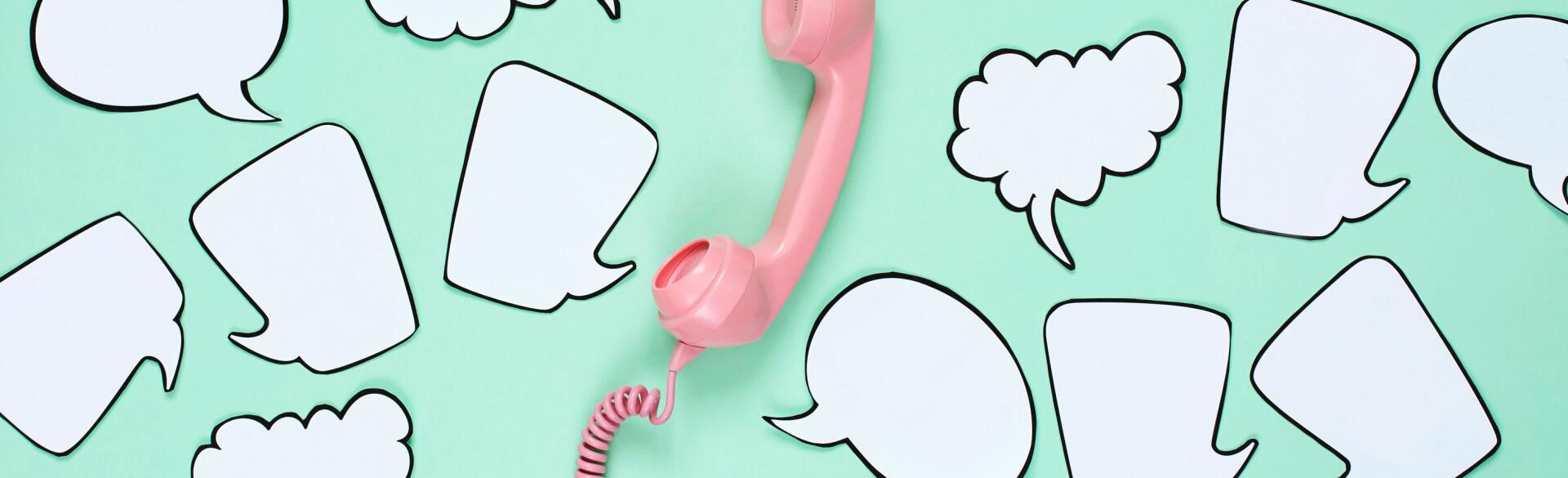 Pink phone used to stay in touch with friends surrounded by speech bubbles.