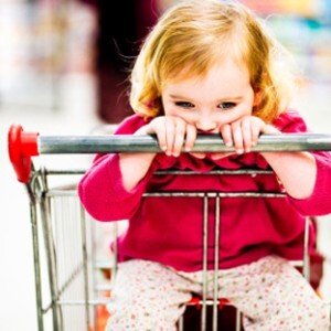 sad girl in grocery cart