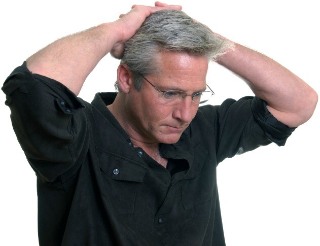 Concerned man with hands on head