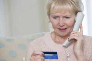 Older woman giving credit card info over the phone