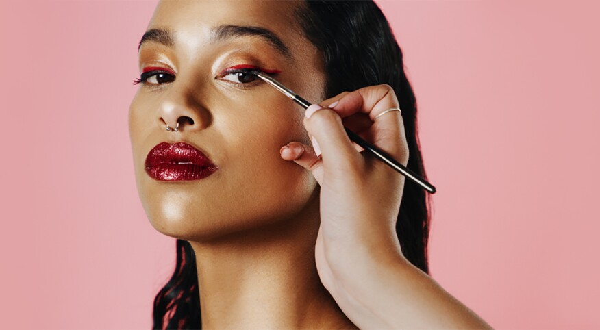 image_of_woman_having_eye_liner_applied_on_eye_GettyImages-1195026344_1440x560_new_1440