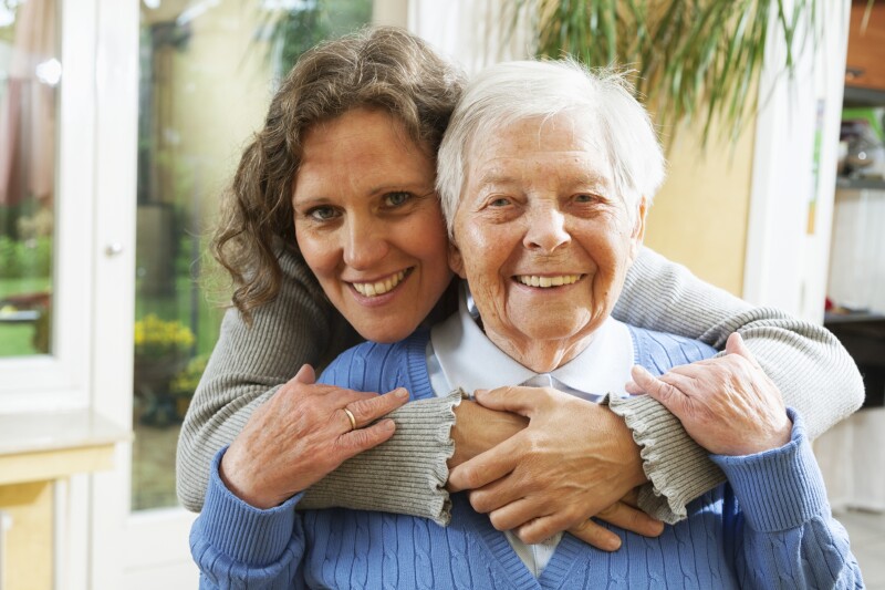 mature woman embracing senior woman