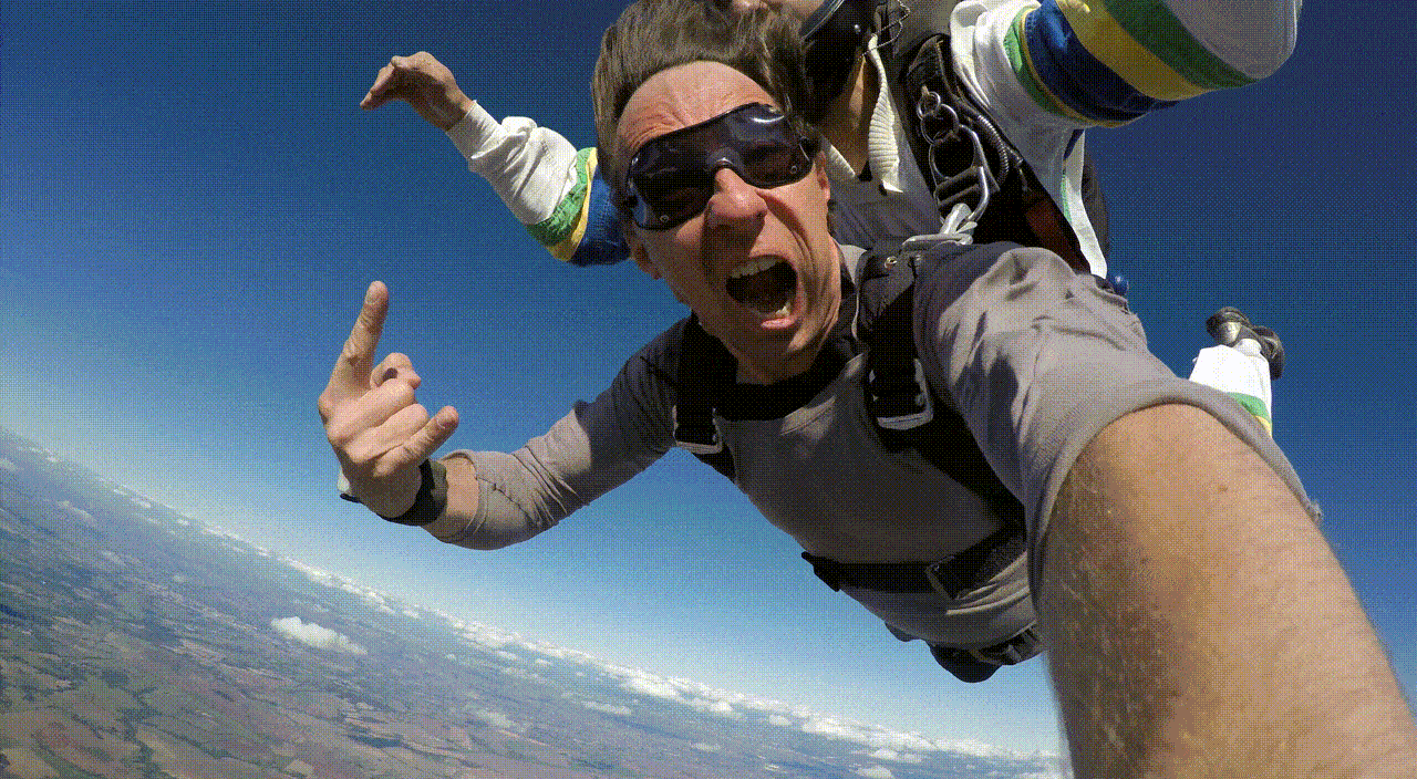 Animated GIF video of a man sky diving, appearing to be shouting out of excitement