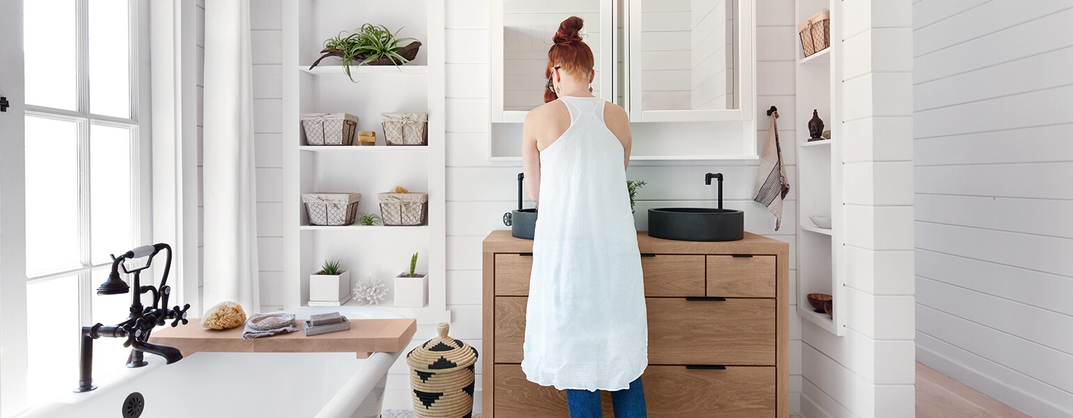 woman washing face while smiling