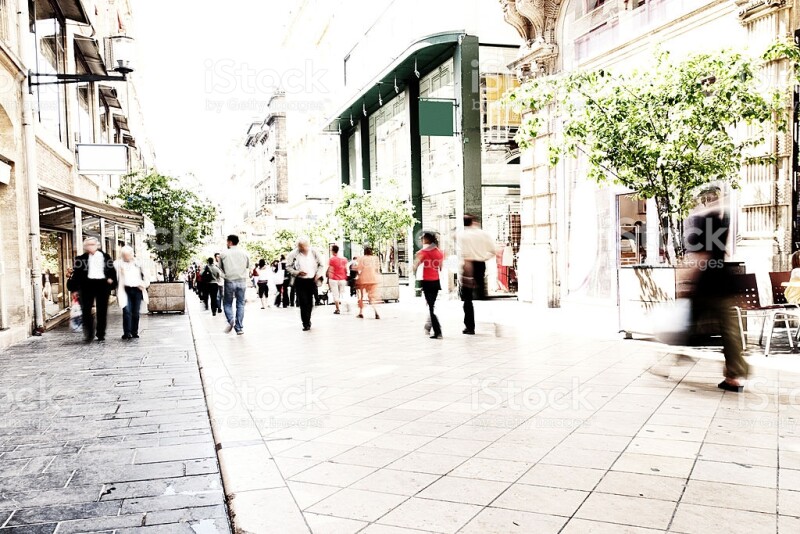 blurry people walking on pedestrian street