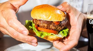 Close up of man holding a burger